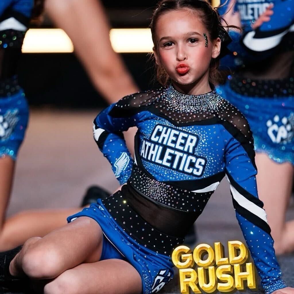 Young Cheer Athletics athlete posing in uniform during a cheer event, supporting gymnastics classes in Chicago and tumbling skill development.